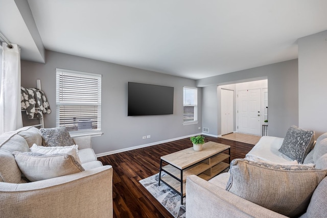 living room with a healthy amount of sunlight and dark wood-type flooring