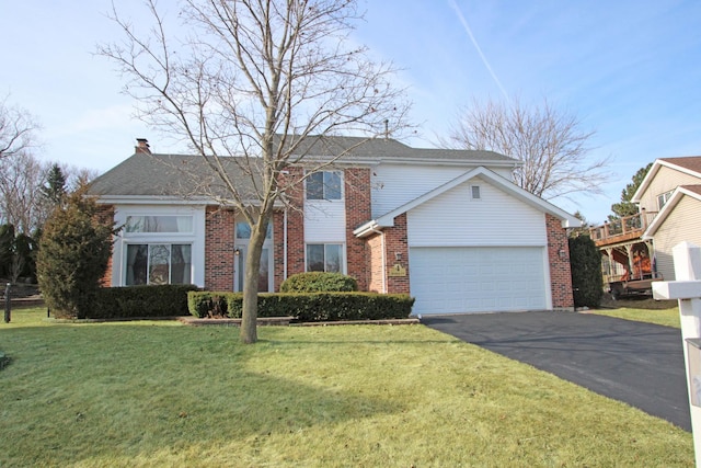 traditional-style house with driveway, an attached garage, a chimney, a front lawn, and brick siding