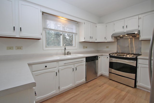 kitchen with sink, white cabinets, stainless steel appliances, and light wood-type flooring