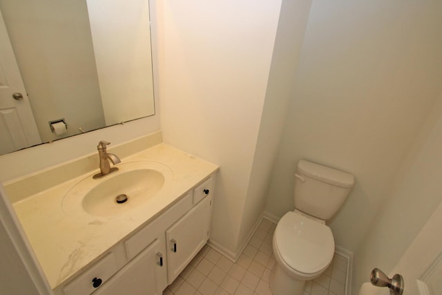 bathroom featuring tile patterned floors, vanity, and toilet