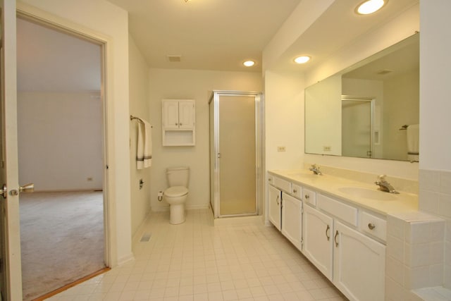 bathroom featuring vanity, toilet, and a shower with shower door