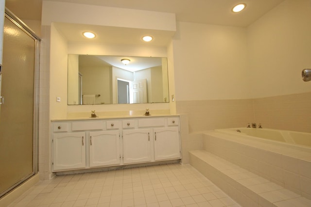 bathroom with tile patterned floors, vanity, and plus walk in shower