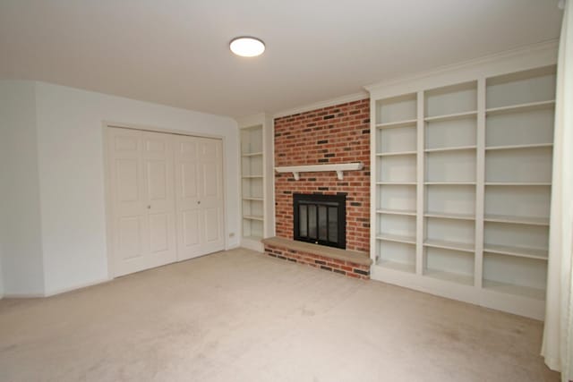 unfurnished living room with carpet floors and a brick fireplace