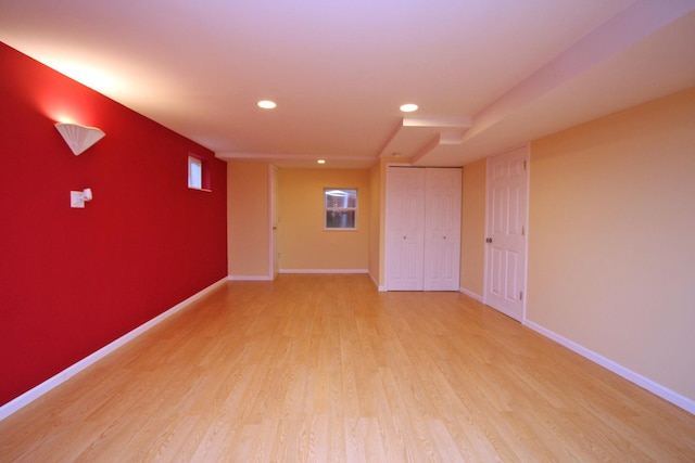 basement with light hardwood / wood-style floors