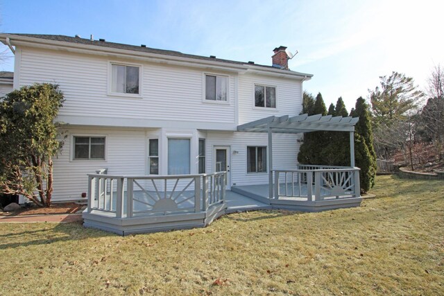 rear view of house featuring a lawn, a pergola, and a deck