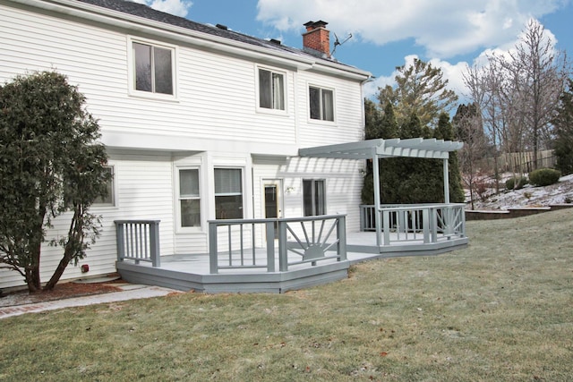 back of house with a pergola, a wooden deck, and a yard