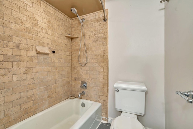 bathroom featuring tiled shower / bath combo and toilet