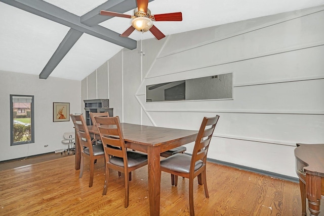 dining room featuring lofted ceiling with beams, light hardwood / wood-style floors, and ceiling fan