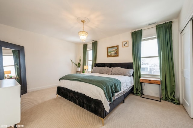 carpeted bedroom with an inviting chandelier, a closet, and multiple windows