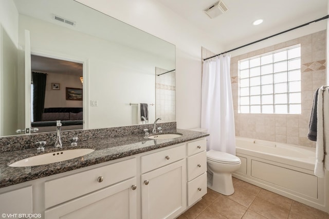 full bathroom featuring tile patterned flooring, shower / bath combination with curtain, vanity, and toilet