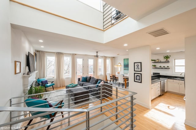 living room featuring sink and light hardwood / wood-style floors