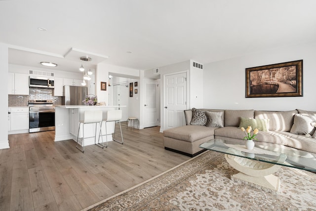 living room with light hardwood / wood-style flooring