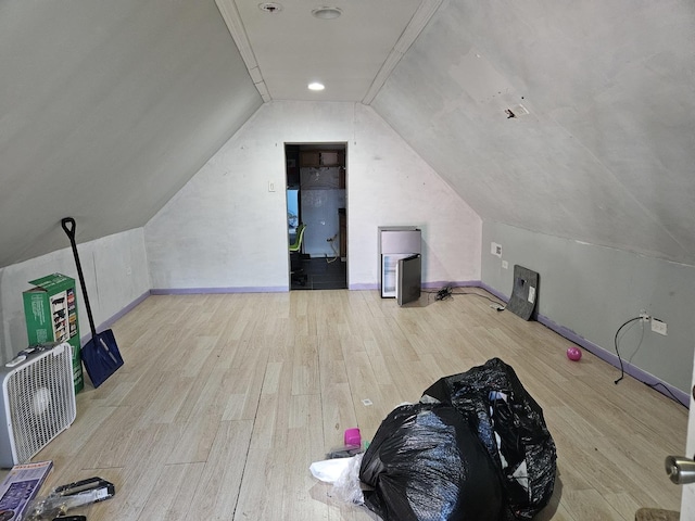 bonus room with light wood-type flooring and lofted ceiling