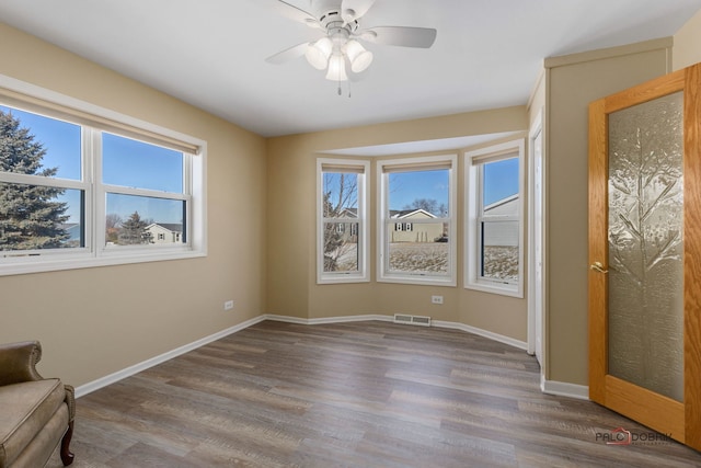 interior space with wood-type flooring and ceiling fan