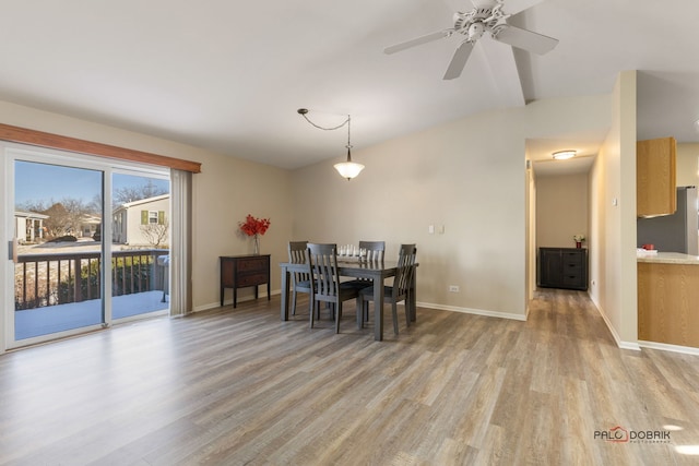 dining room with lofted ceiling, ceiling fan, and light wood-type flooring