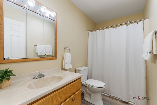 bathroom featuring vanity, toilet, and hardwood / wood-style floors