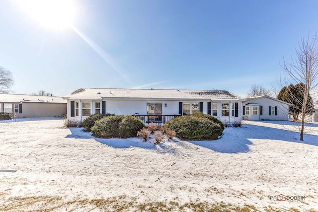 snow covered property featuring a deck