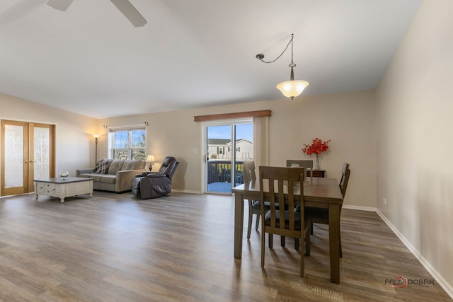 dining area featuring vaulted ceiling, dark hardwood / wood-style flooring, and french doors