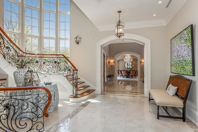 entrance foyer featuring ornamental molding and an inviting chandelier