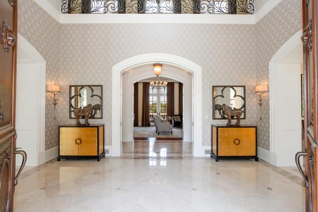 entryway featuring a towering ceiling and a notable chandelier