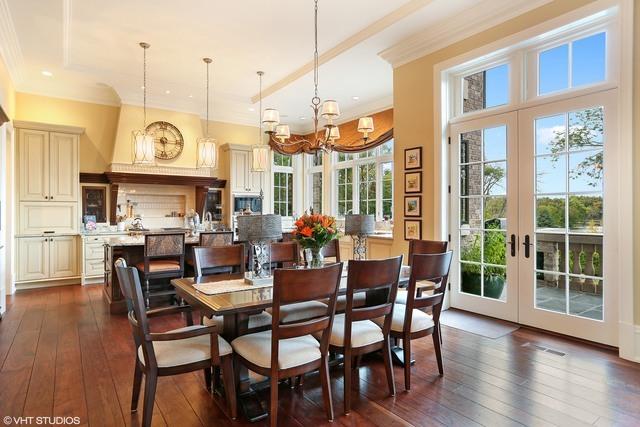 dining room with french doors, dark hardwood / wood-style flooring, a raised ceiling, and a notable chandelier