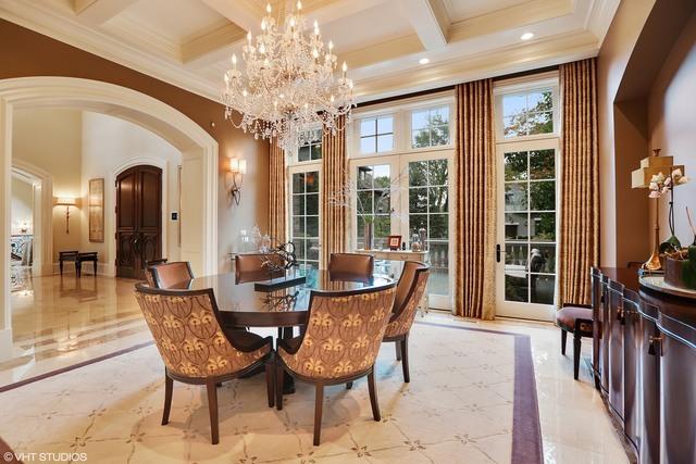 dining area with beam ceiling, coffered ceiling, a notable chandelier, crown molding, and a towering ceiling