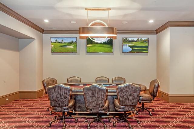 dining room with carpet floors and crown molding