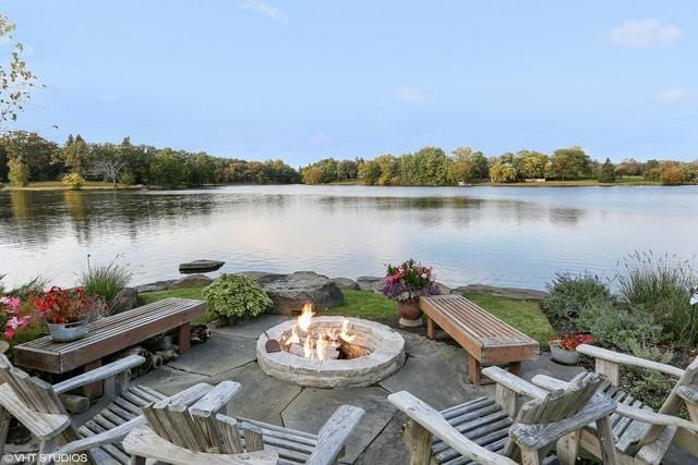 dock area with a patio, a water view, and a fire pit