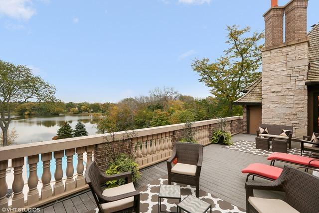 wooden deck with an outdoor living space and a water view