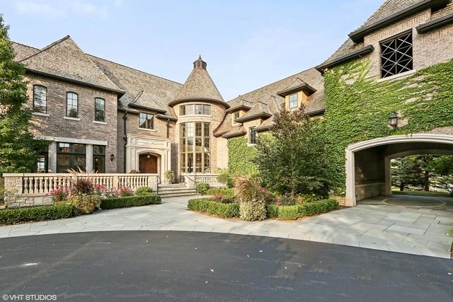 french provincial home featuring a carport