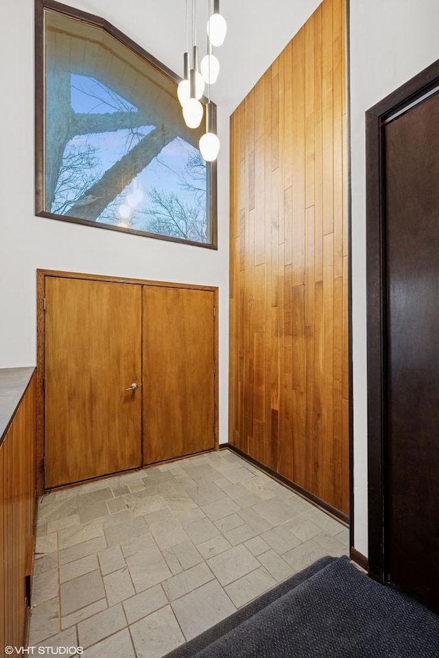 unfurnished dining area with wood walls