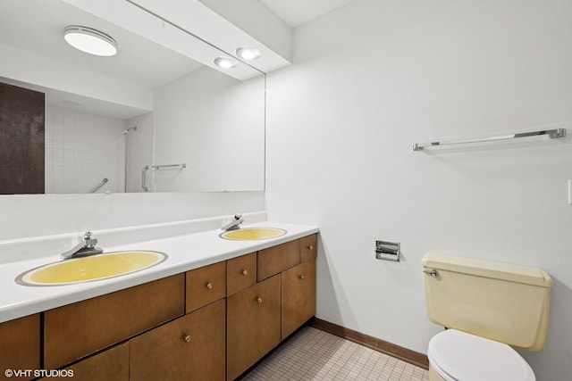 full bathroom featuring toilet, tile patterned flooring, baseboards, and a sink