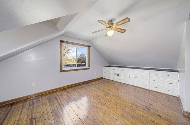 bonus room featuring hardwood / wood-style flooring, vaulted ceiling, and ceiling fan