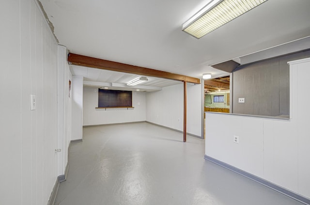 basement featuring wood walls