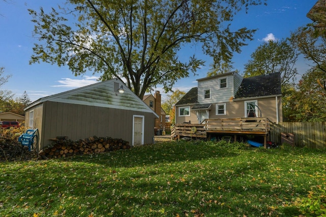 back of property featuring a yard and a deck