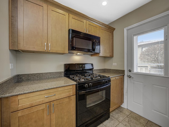 kitchen featuring black appliances, stone countertops, and light tile patterned flooring