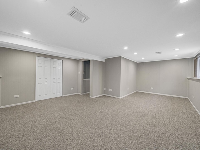 basement with carpet floors and ornamental molding