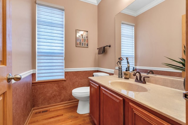 bathroom with hardwood / wood-style floors, vanity, ornamental molding, and toilet