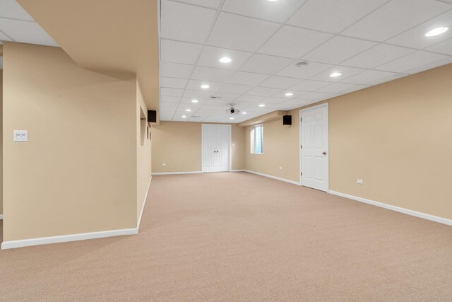 basement featuring light colored carpet