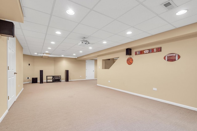 basement featuring carpet floors and a paneled ceiling