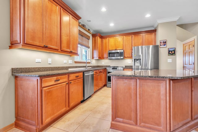 kitchen with appliances with stainless steel finishes, ornamental molding, sink, light tile patterned floors, and a center island