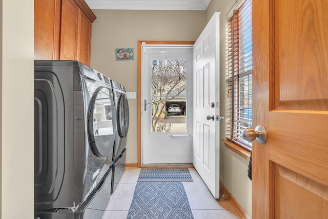 laundry room featuring cabinets, independent washer and dryer, and light tile patterned floors