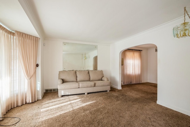 unfurnished living room with carpet, a notable chandelier, crown molding, and a wealth of natural light