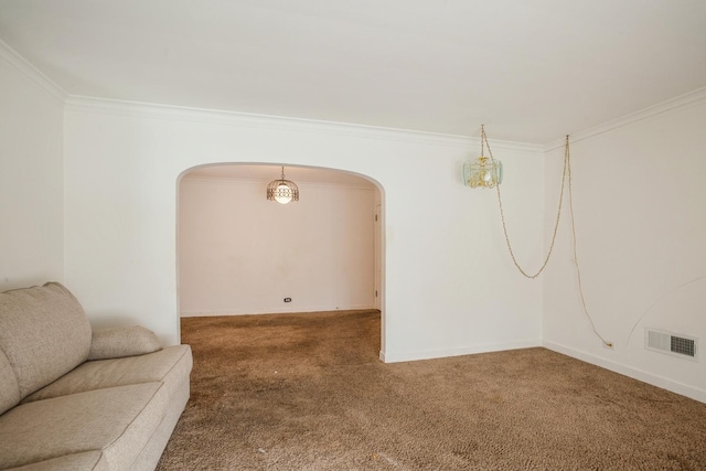 carpeted spare room featuring crown molding