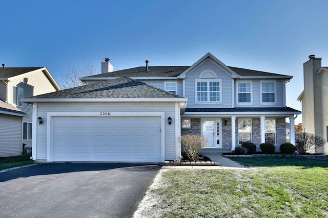 view of front property with a garage and a front yard