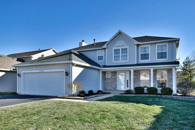 front of property with a garage and a front lawn