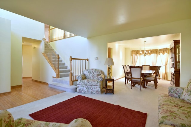 living room with light hardwood / wood-style floors and an inviting chandelier