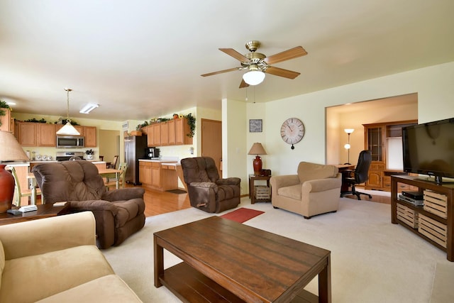 living room featuring ceiling fan and light colored carpet