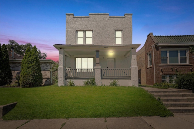 view of front of home featuring a porch and a yard