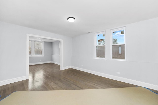 unfurnished room featuring dark wood-type flooring